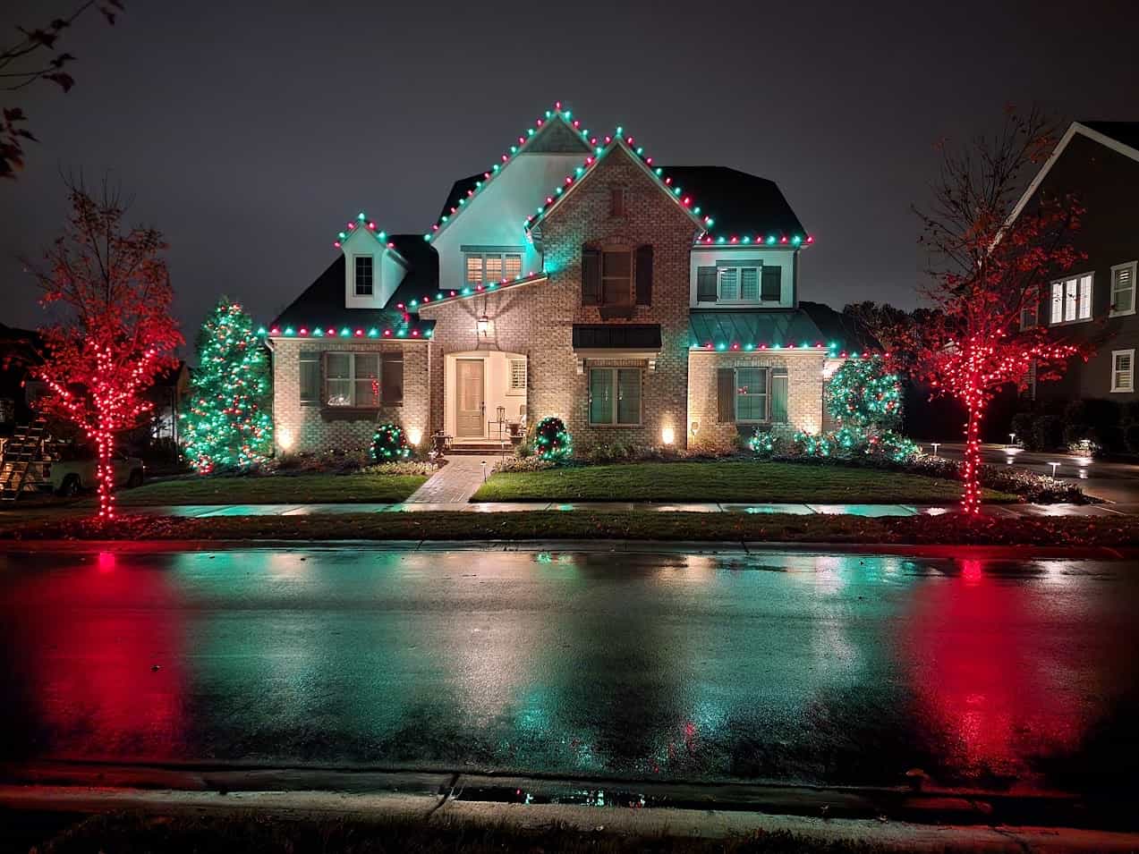 Professional red and green holiday lighting on a Charlotte-area home