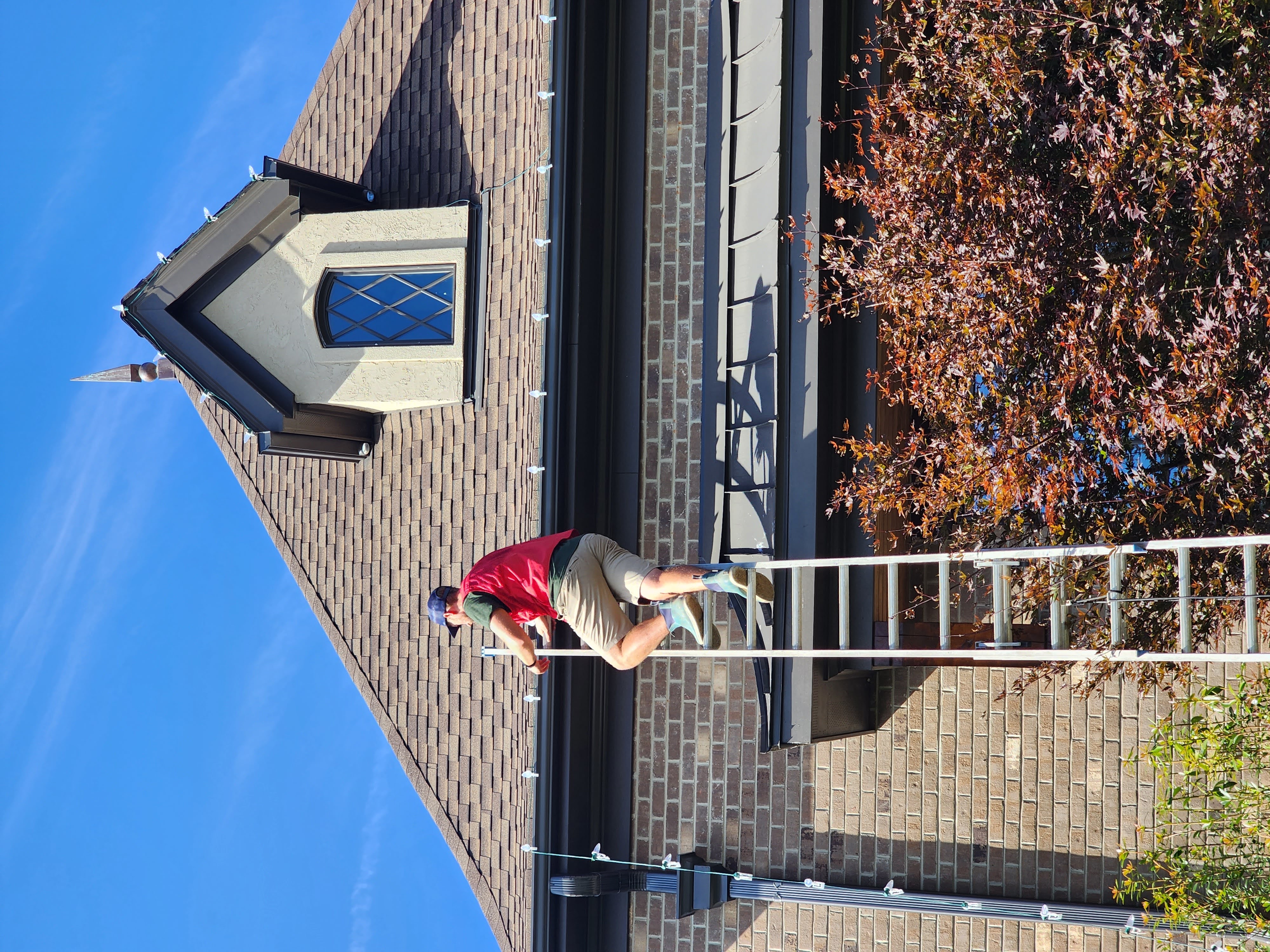 Installer learning professional Christmas light roofline installation
